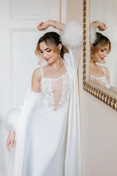 Final bridal touches surrounded by bridesmaids in an elegant hotel room